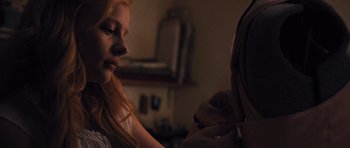 Movie still from “Carrie” (2013), directed by Kimberly Peirce – A woman with red hair is looking at a man; Close Up shot, Over the shoulder angle