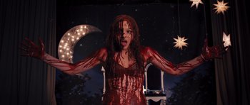 Movie still from “Carrie” (2013), directed by Kimberly Peirce – A woman with blood all over her face and body; Medium shot, High angle