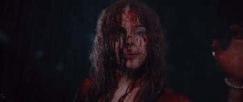 Movie still from “Carrie” (2013), directed by Kimberly Peirce – A woman with blood all over her face and body; Close Up shot, Low angle