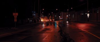 Movie still from “Carrie” (2013), directed by Kimberly Peirce – A city street at night lit by street lights; Extreme Wide shot, High angle