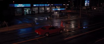 Movie still from “Carrie” (2013), directed by Kimberly Peirce – A red car parked on the side of the road at night; Extreme Wide shot, High angle
