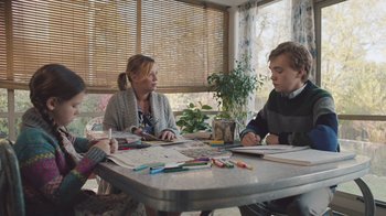 Movie still from “The Clovehitch Killer” (2018), directed by Duncan Skiles – Three people sitting at a dining room table; Medium shot, Over the shoulder angle