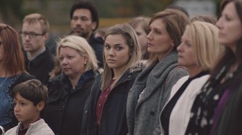 Movie still from “The Clovehitch Killer” (2018), directed by Duncan Skiles – A group of people standing in front of each other; Close Up shot, Over the shoulder angle