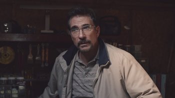 Movie still from “The Clovehitch Killer” (2018), directed by Duncan Skiles – A person wearing glasses and a jacket; Close Up shot, Over the shoulder angle