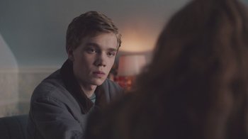 Movie still from “The Clovehitch Killer” (2018), directed by Duncan Skiles – A young man sitting in front of a woman in a room; Close Up shot, Over the shoulder angle