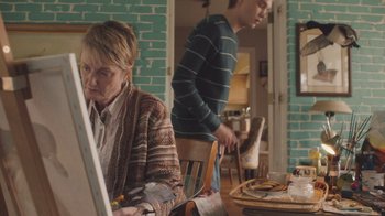 Movie still from “The Clovehitch Killer” (2018), directed by Duncan Skiles – A man and a woman are sitting at a dining room table; Medium shot, Over the shoulder angle