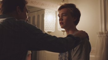 Movie still from “The Clovehitch Killer” (2018), directed by Duncan Skiles – A young man getting his hair combed by an older man; Close Up shot, Over the shoulder angle