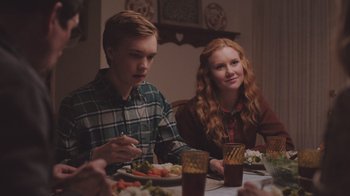 Movie still from “The Clovehitch Killer” (2018), directed by Duncan Skiles – A group of people sitting at a dinner table; Medium shot, Over the shoulder angle