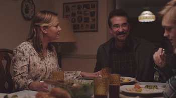 Movie still from “The Clovehitch Killer” (2018), directed by Duncan Skiles – A man and a woman sitting at a dinner table; Medium shot, Over the shoulder angle