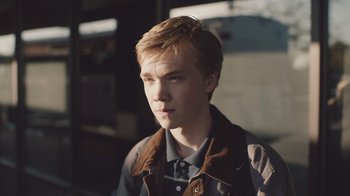 Movie still from “The Clovehitch Killer” (2018), directed by Duncan Skiles – A young man is looking into the distance; Close Up shot, Low angle