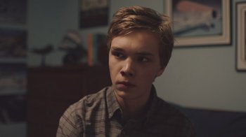 Movie still from “The Clovehitch Killer” (2018), directed by Duncan Skiles – A young man is looking into the distance; Close Up shot, Over the shoulder angle