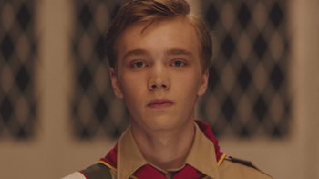 Movie still from “The Clovehitch Killer” (2018), directed by Duncan Skiles – A person wearing a uniform; Close Up shot, Low angle