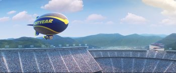 Movie still from “Cars 3” (2017), directed by Brian Fee – A balloon flying over a stadium filled with fans; Extreme Wide shot, Low angle