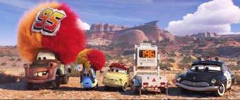 Movie still from “Cars 3” (2017), directed by Brian Fee – The cars are parked on the side of the road; Wide shot, Low angle