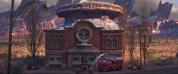 Movie still from “Cars 3” (2017), directed by Brian Fee – A fire truck is parked in front of a fire station; Extreme Wide shot, Low angle
