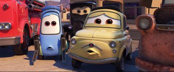 Movie still from “Cars 3” (2017), directed by Brian Fee – A group of cartoon characters that are standing next to each other; Wide shot, Low angle