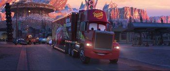 Movie still from “Cars 3” (2017), directed by Brian Fee – A large semi truck with a trailer on it's side; Wide shot, Low angle