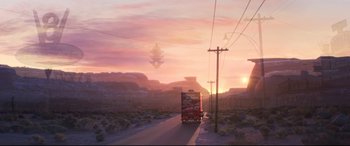 Movie still from “Cars 3” (2017), directed by Brian Fee – A truck driving down a road in the middle of the desert; Extreme Wide shot, Low angle