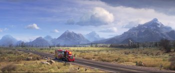 Movie still from “Cars 3” (2017), directed by Brian Fee – A fire truck is driving down the road; Extreme Wide shot, High angle