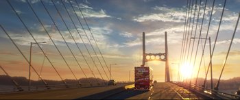 Movie still from “Cars 3” (2017), directed by Brian Fee – A truck driving down a road under a bridge; Extreme Wide shot, Low angle
