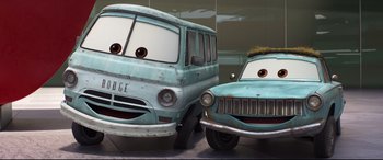 Movie still from “Cars 3” (2017), directed by Brian Fee – A couple of cars that are next to each other; Medium shot, Low angle
