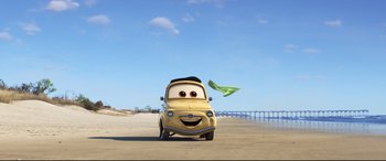 Movie still from “Cars 3” (2017), directed by Brian Fee – A yellow car with eyes and a black hat on the hood; Extreme Wide shot, Low angle