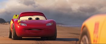 Movie still from “Cars 3” (2017), directed by Brian Fee – The front end of a red car; Medium shot, Low angle