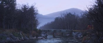 Movie still from “Cars 3” (2017), directed by Brian Fee – A bridge over a river in a wooded area; Extreme Wide shot, High angle