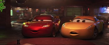 Movie still from “Cars 3” (2017), directed by Brian Fee – A couple of cars that are next to each other; Wide shot, Over the shoulder angle