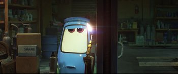 Movie still from “Cars 3” (2017), directed by Brian Fee – A cartoon character's eyes as he pumps gas into a tank; Medium shot, Low angle