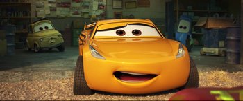 Movie still from “Cars 3” (2017), directed by Brian Fee – The face of a yellow car; Close Up shot, Low angle