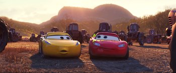 Movie still from “Cars 3” (2017), directed by Brian Fee – A couple of cars that are next to each other; Wide shot, Low angle
