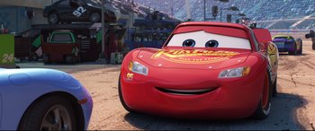 Movie still from “Cars 3” (2017), directed by Brian Fee – The face of a red car; Medium shot, Low angle