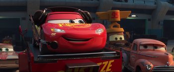 Movie still from “Cars 3” (2017), directed by Brian Fee – A red car in a scene from cars 3; Medium shot, Low angle