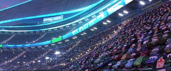 Movie still from “Cars 3” (2017), directed by Brian Fee – A stadium filled with lots of cars at night time; Extreme Wide shot, High angle