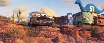 Movie still from “Cars 3” (2017), directed by Brian Fee – A car and a tow truck on a rocky hill; Wide shot, Low angle