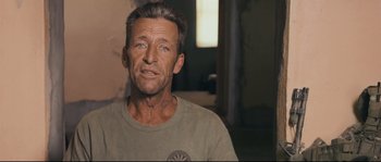 Movie still from “Cartel Land” (2015), directed by Matthew Heineman – A person wearing a t - shirt; Close Up shot, Over the shoulder angle