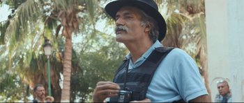 Movie still from “Cartel Land” (2015), directed by Matthew Heineman – An older man in a black hat holding a camera; Close Up shot, Low angle