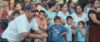 Movie still from “Cartel Land” (2015), directed by Matthew Heineman – A large group of people standing in front of each other; Medium shot, Over the shoulder angle