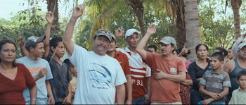 Movie still from “Cartel Land” (2015), directed by Matthew Heineman – A group of men standing next to each other holding their hands up; Medium shot, High angle