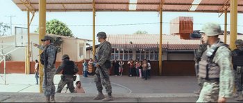 Movie still from “Cartel Land” (2015), directed by Matthew Heineman – A man in military fatigues holding a gun; Extreme Wide shot, Low angle