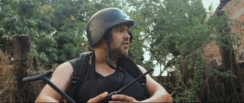 Movie still from “Cartel Land” (2015), directed by Matthew Heineman – A man wearing a helmet and holding a stick; Close Up shot, Low angle