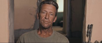 Movie still from “Cartel Land” (2015), directed by Matthew Heineman – A person wearing a t - shirt; Close Up shot, Over the shoulder angle