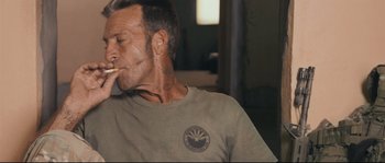 Movie still from “Cartel Land” (2015), directed by Matthew Heineman – A person smoking a marijuana cigarette; Close Up shot, Low angle