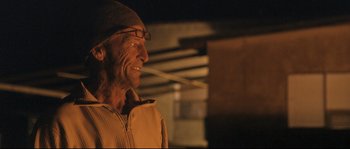 Movie still from “Cartel Land” (2015), directed by Matthew Heineman – An old man wearing glasses and a hat; Close Up shot, Over the shoulder angle