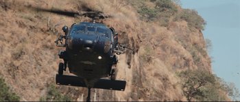 Movie still from “Cartel Land” (2015), directed by Matthew Heineman – A helicopter is flying over a cliff face; Extreme Wide shot, Low angle