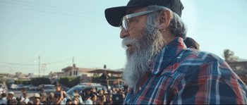 Movie still from “Cartel Land” (2015), directed by Matthew Heineman – An older man with a long beard and glasses; Medium shot, Low angle