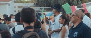 Movie still from “Cartel Land” (2015), directed by Matthew Heineman – A group of people standing next to each other on a field; Medium shot, Over the shoulder angle