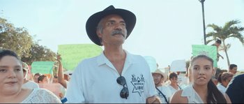 Movie still from “Cartel Land” (2015), directed by Matthew Heineman – A man in a white shirt and a black hat; Close Up shot, Low angle