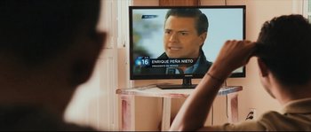 Movie still from “Cartel Land” (2015), directed by Matthew Heineman – A television screen with a picture of a man on it; Close Up shot, Over the shoulder angle